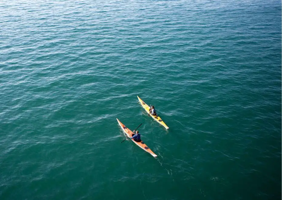 Two people kayaking in the sea considering a 10ft vs 12 foot kayak