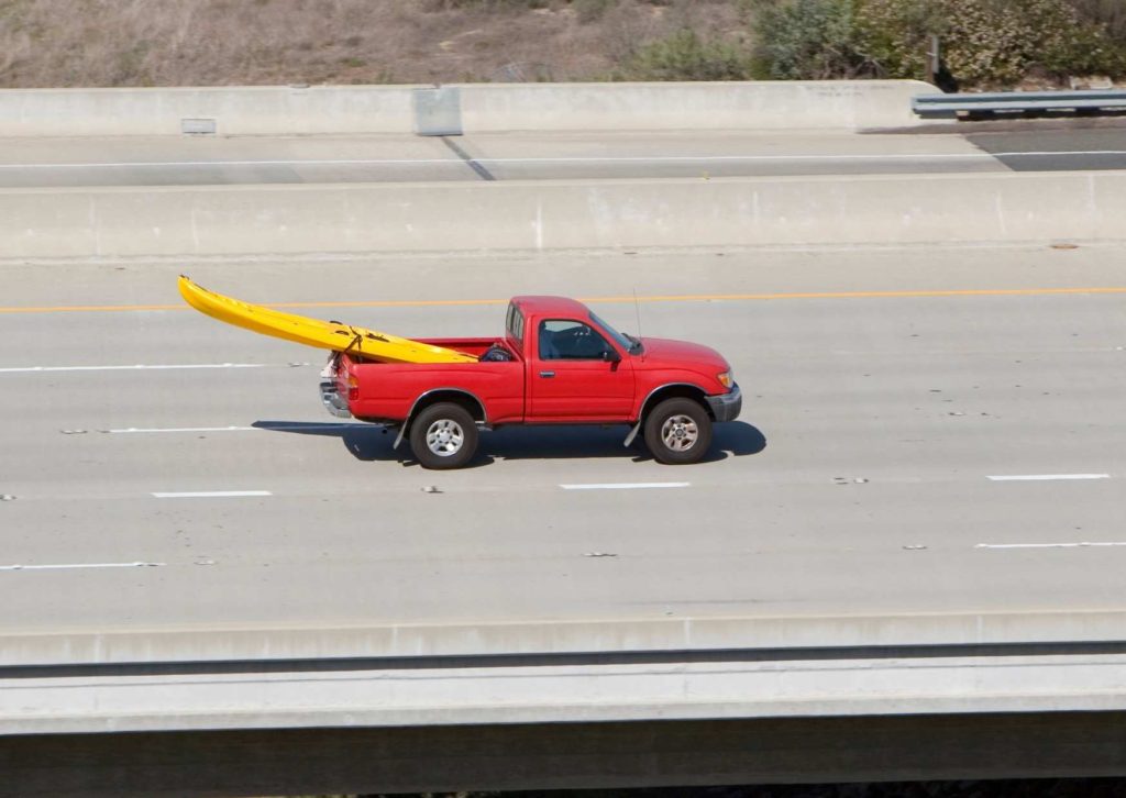 A truck with a kayak in the back - one of 6 ways to transport a kayak in truck with a truck bed