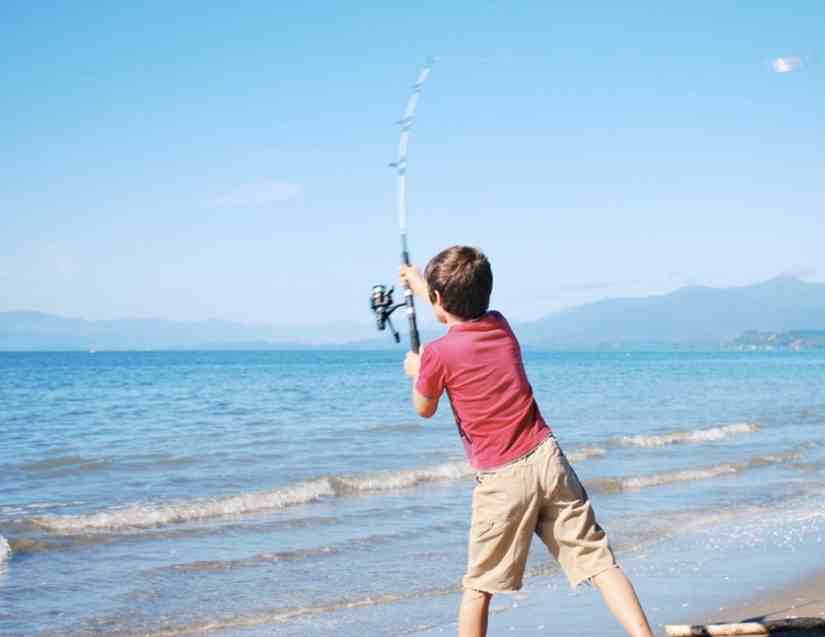 A boy casting thinking, can you surf fish with a 7 foot rod