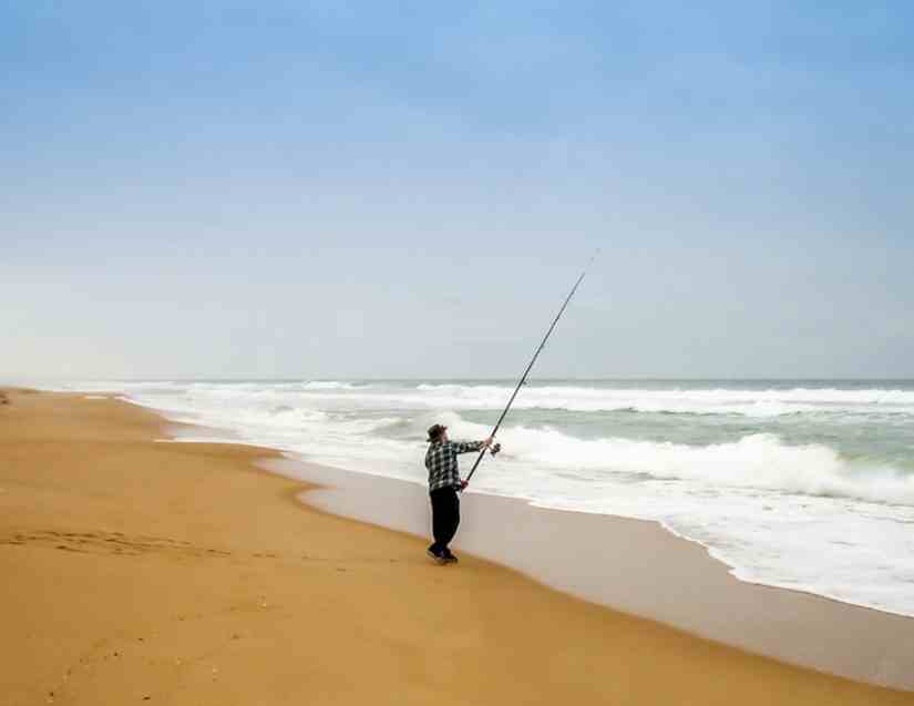 A-man-fishing-and-thinking-what-size-rod-for-beach-fishing